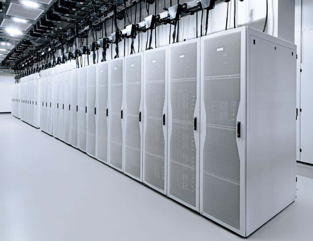 A long row of white enterprise server rack enclosures in a modern, professional data center environment.
